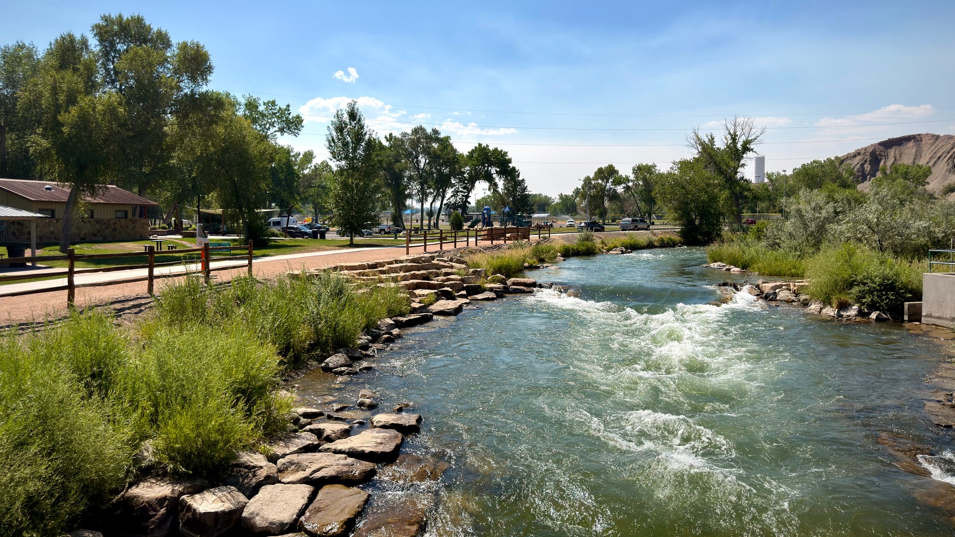 The Uncompahgre River flowing through a green landscape near Montrose, Colorado