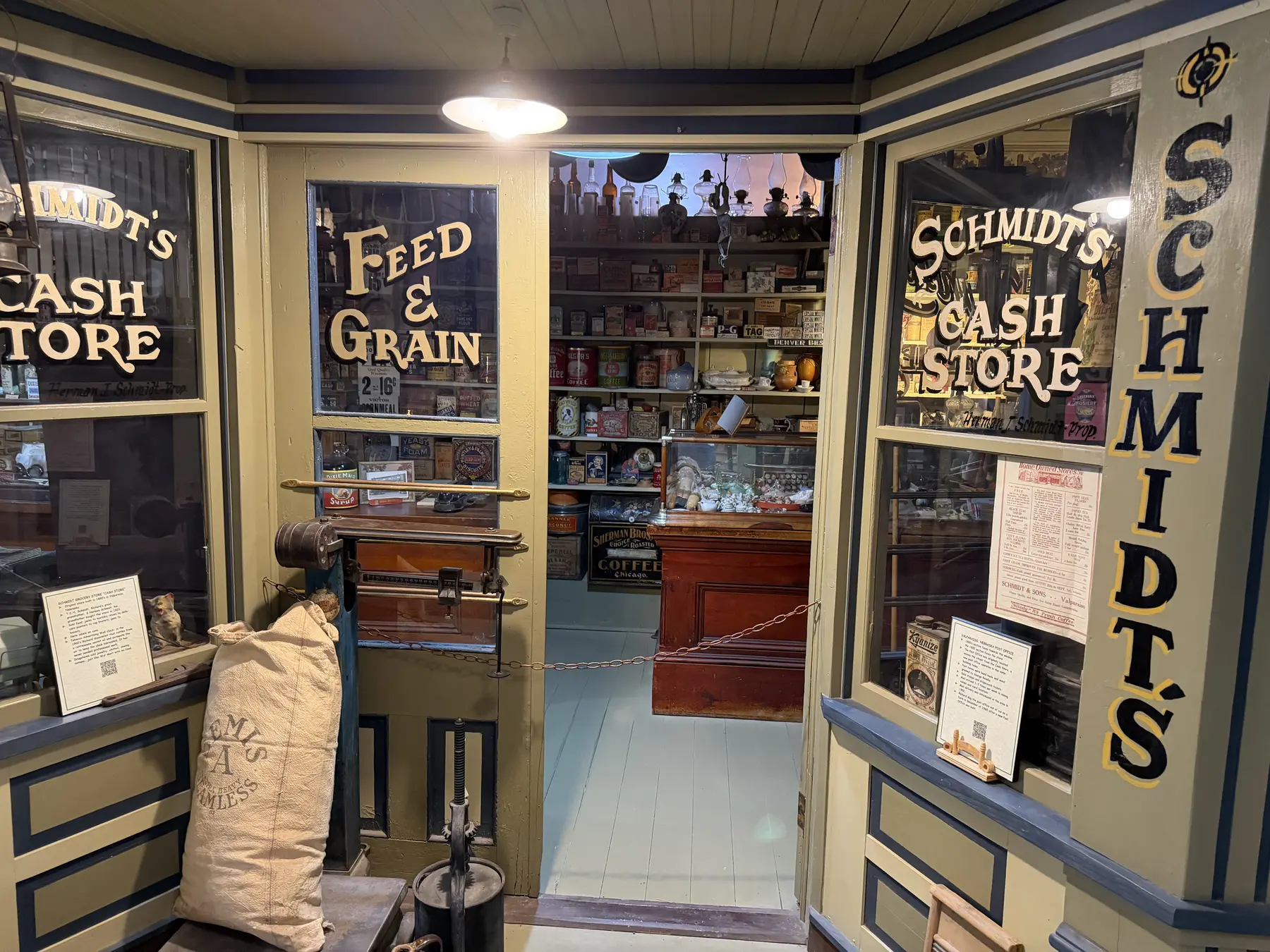 The entrance to a reconstructed feed and grain store filled with shelves and period goods