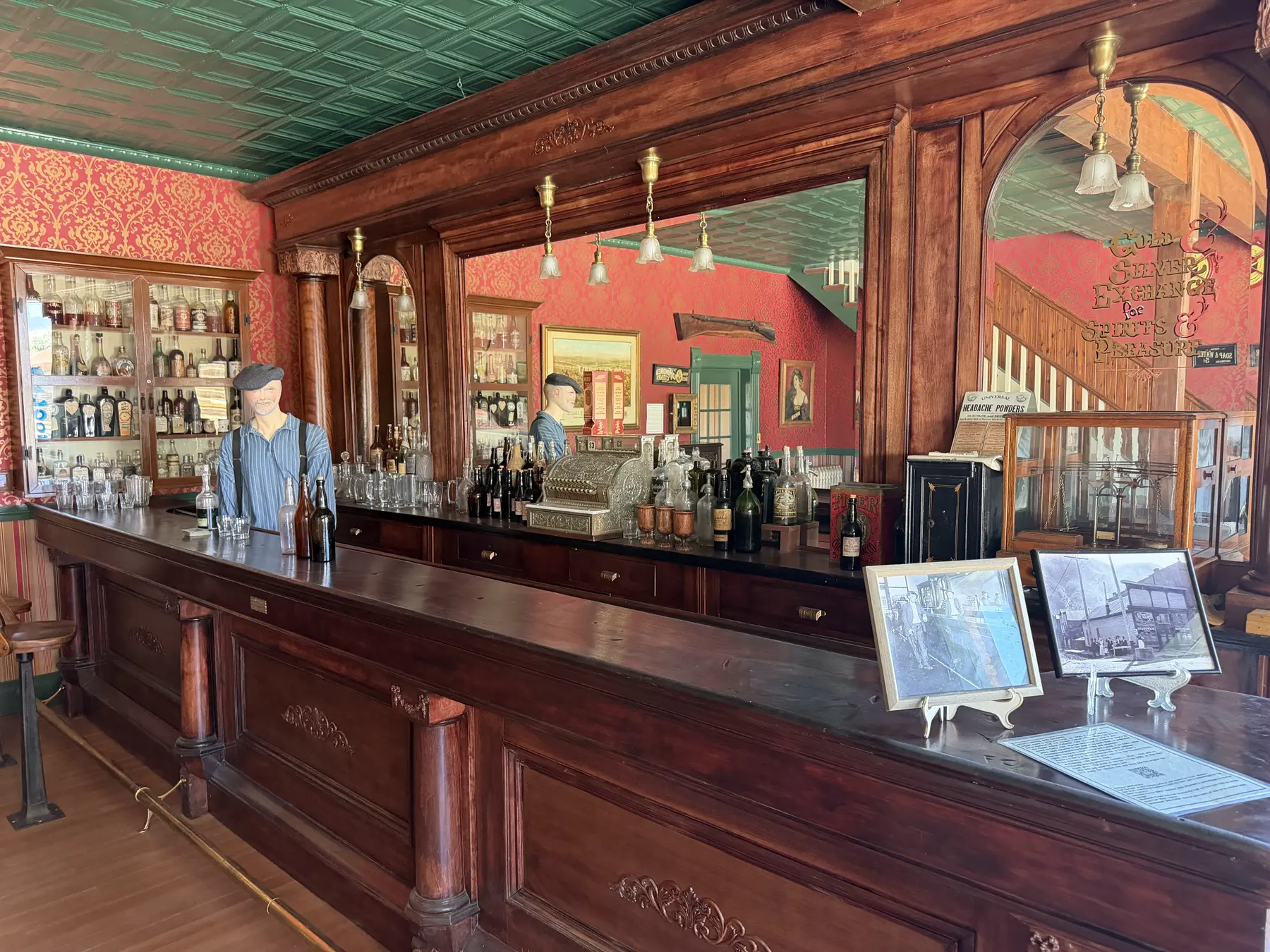 A restored Old West saloon with a long wooden bar and period furnishings